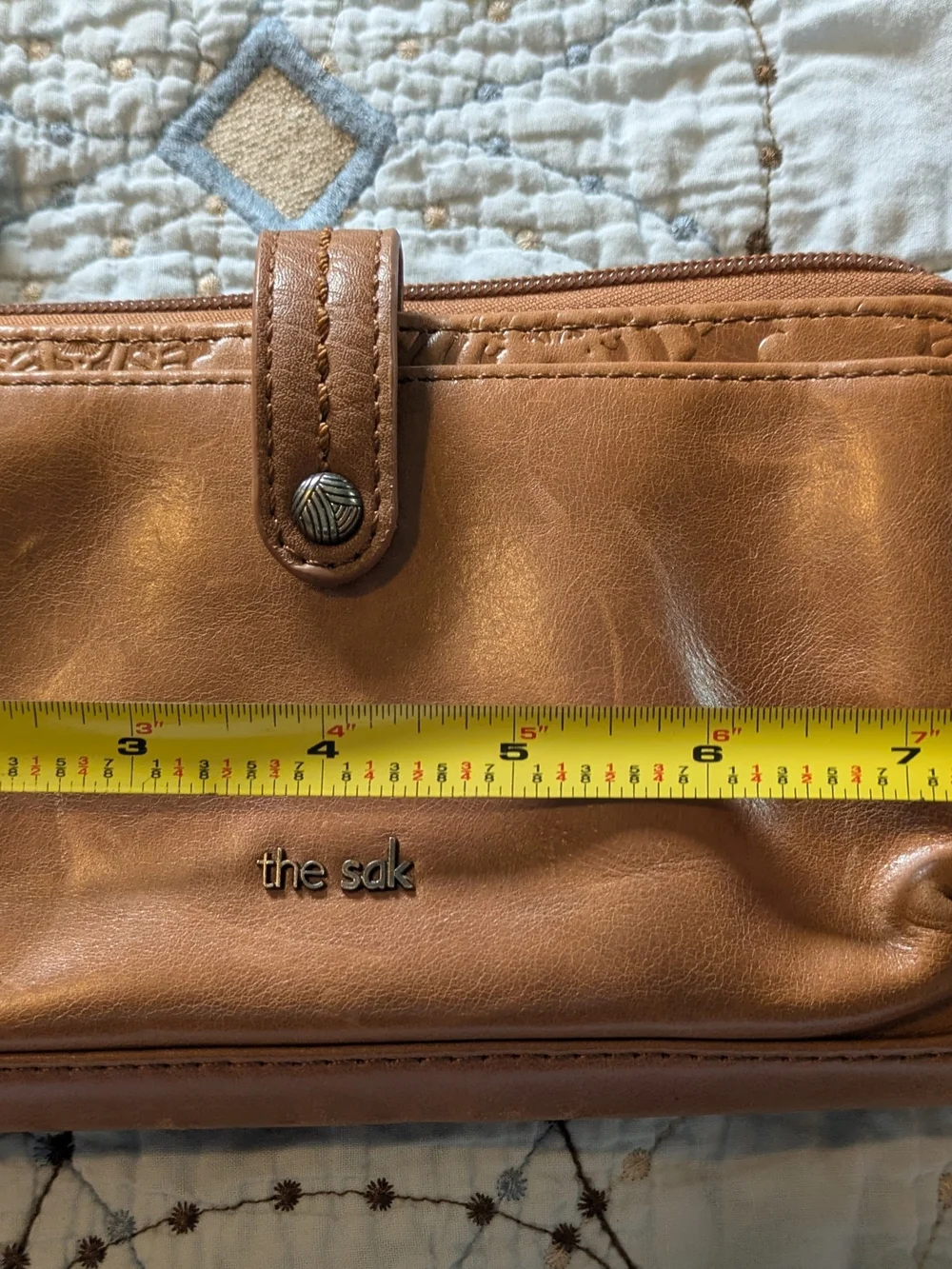 The Sak tan leatherette crossbody wristlet